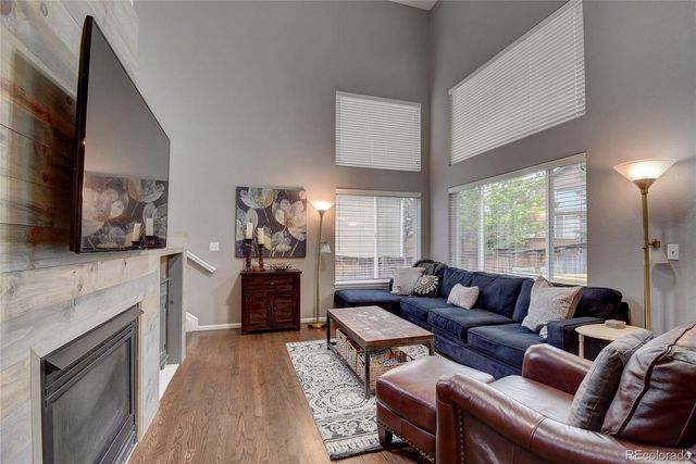 a living room with furniture fireplace and flat screen tv