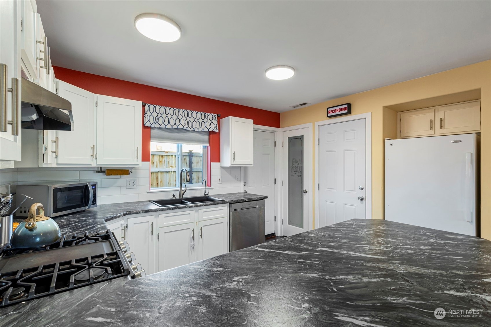 3957 Broadmoor Loop Bremerton, WA 98310 - Photo 8 of 23 a kitchen with stainless steel appliances granite countertop a sink stove and refrigerator