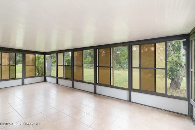 a view of an empty room with windows