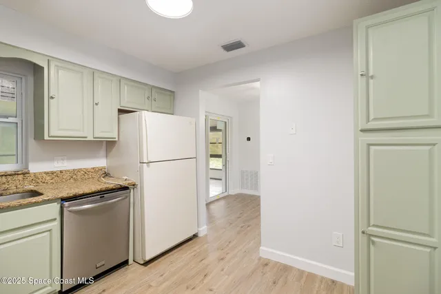 a white refrigerator freezer sitting in a kitchen