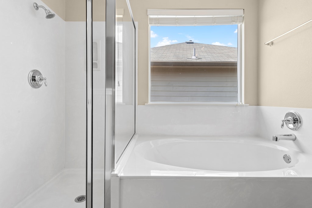 458 Nottingham Loop Kyle, TX 78640 - Photo 24 of 38 a white bath tub sitting next to a white cabinet