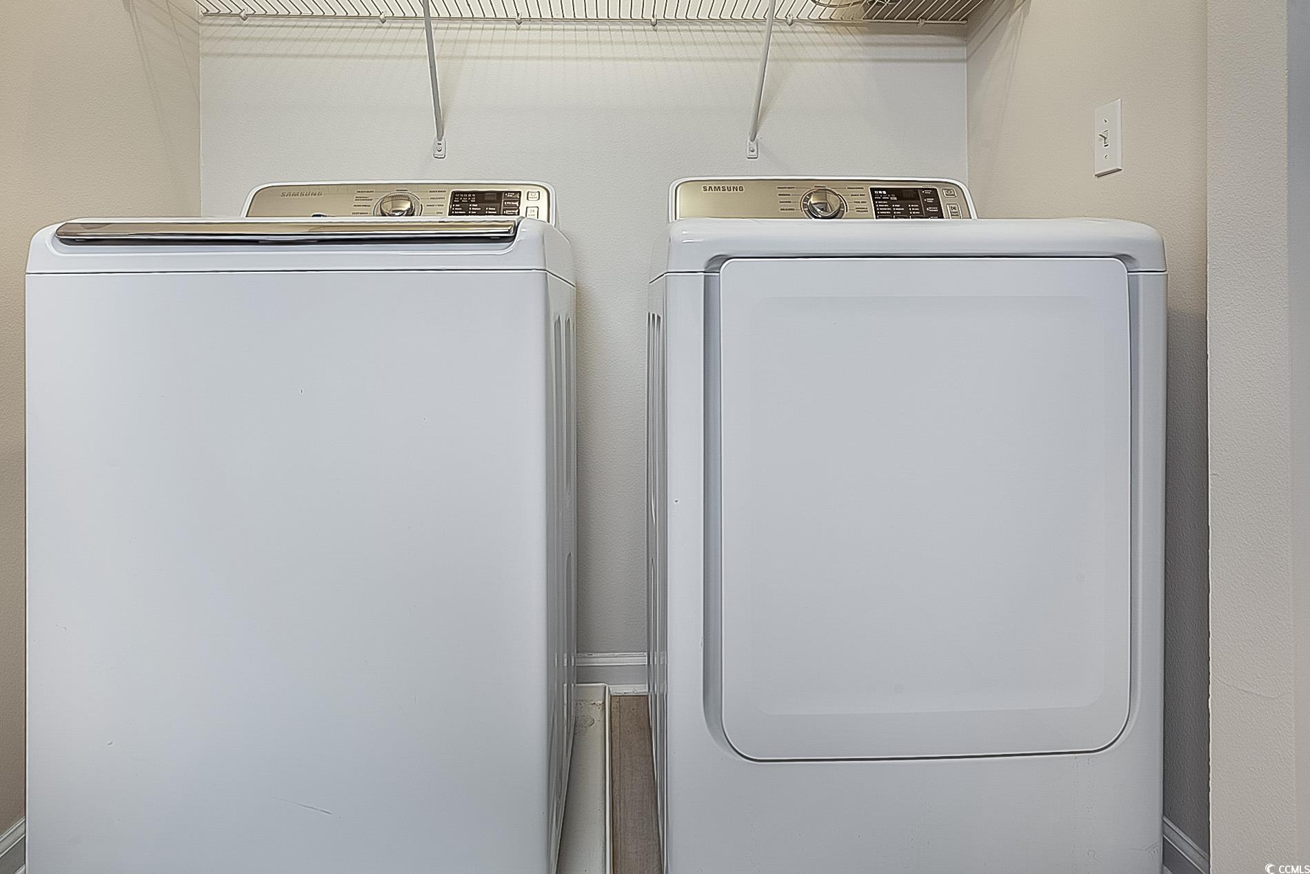 1204 River Oaks Drive, Unit 25D Myrtle Beach, SC 29579 - Photo 13 of 31 Laundry area with washer and clothes dryer and wood finished floors