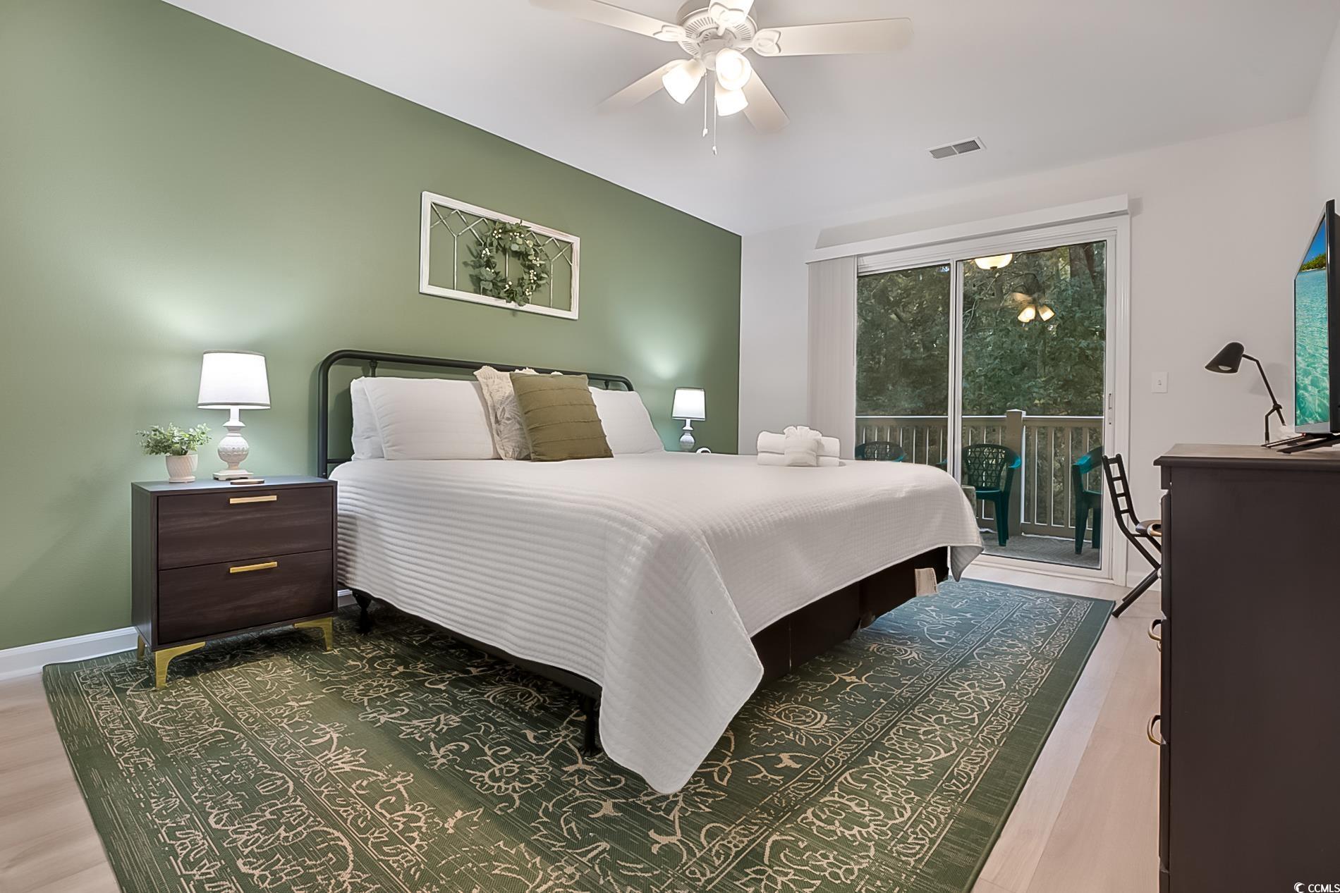 1204 River Oaks Drive, Unit 25D Myrtle Beach, SC 29579 - Photo 14 of 31 Bedroom with access to exterior, ceiling fan, and wood finished floors