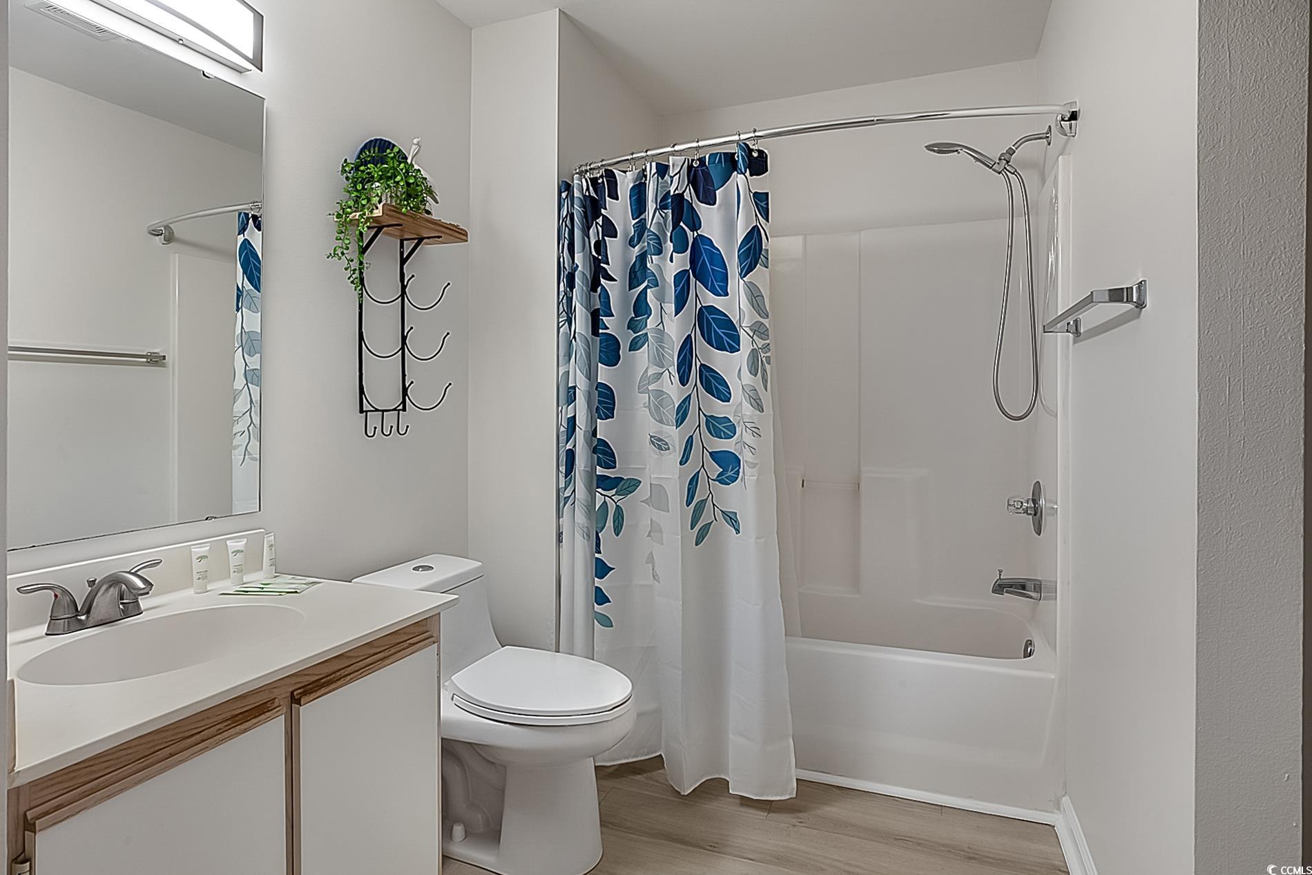1204 River Oaks Drive, Unit 25D Myrtle Beach, SC 29579 - Photo 19 of 31 Bathroom featuring vanity, light wood-style flooring, and shower / tub combo with curtain