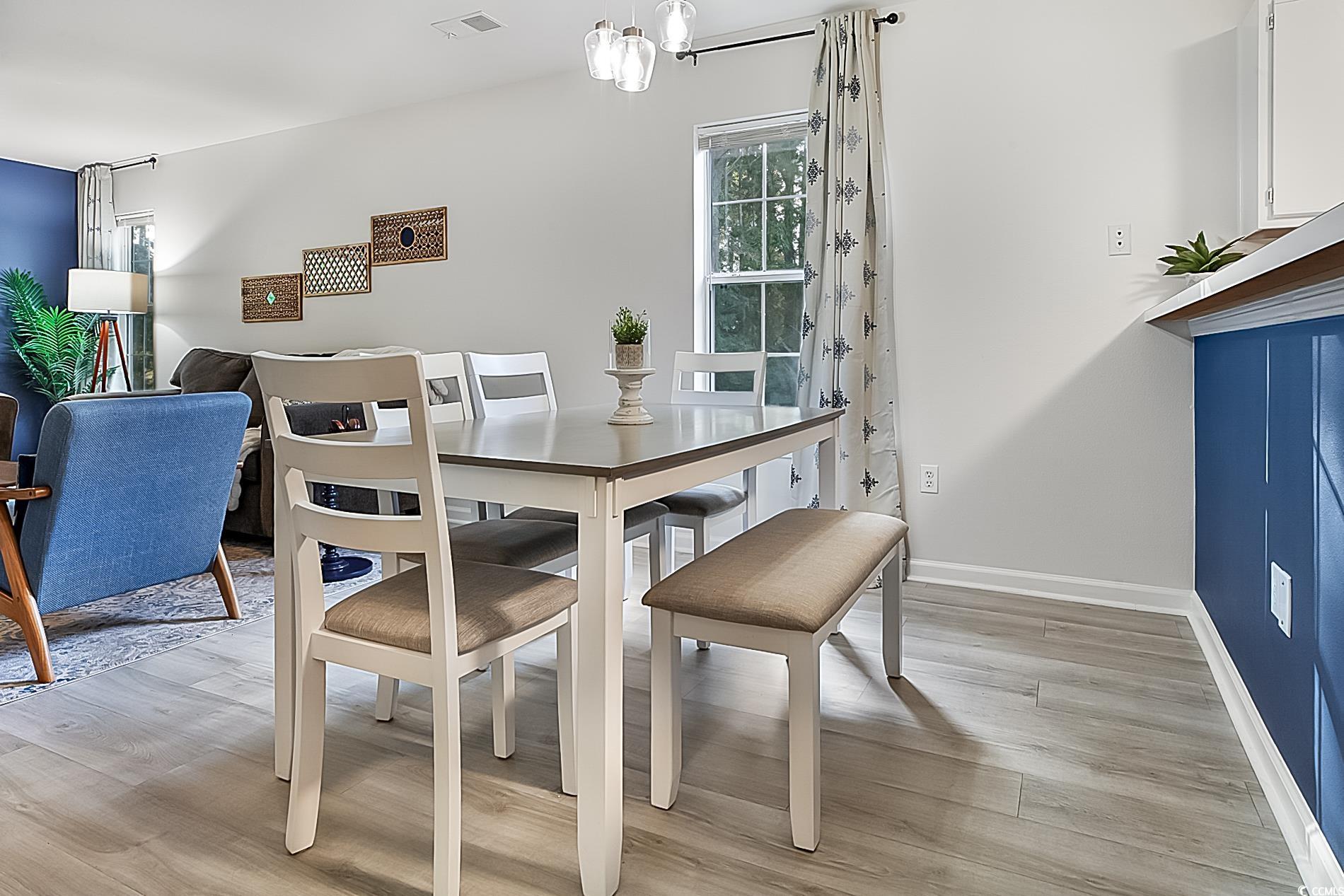 1204 River Oaks Drive, Unit 25D Myrtle Beach, SC 29579 - Photo 7 of 31 Dining room with light wood-style floors and a chandelier