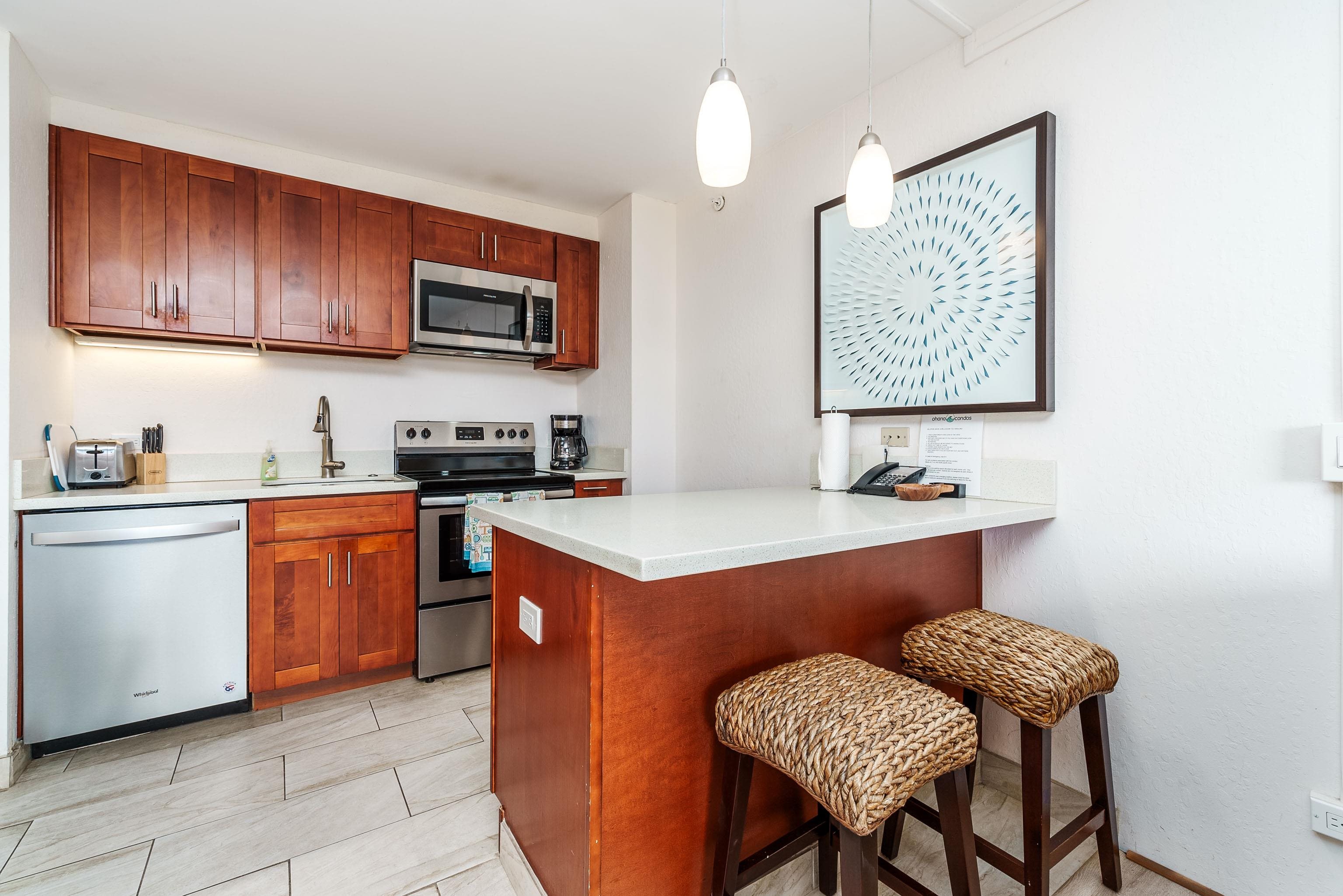3445 Lower Honoapiilani Road, Unit 434 Lahaina, HI 96761 - Photo 12 of 46 a kitchen with stainless steel appliances granite countertop a sink counter space and cabinets