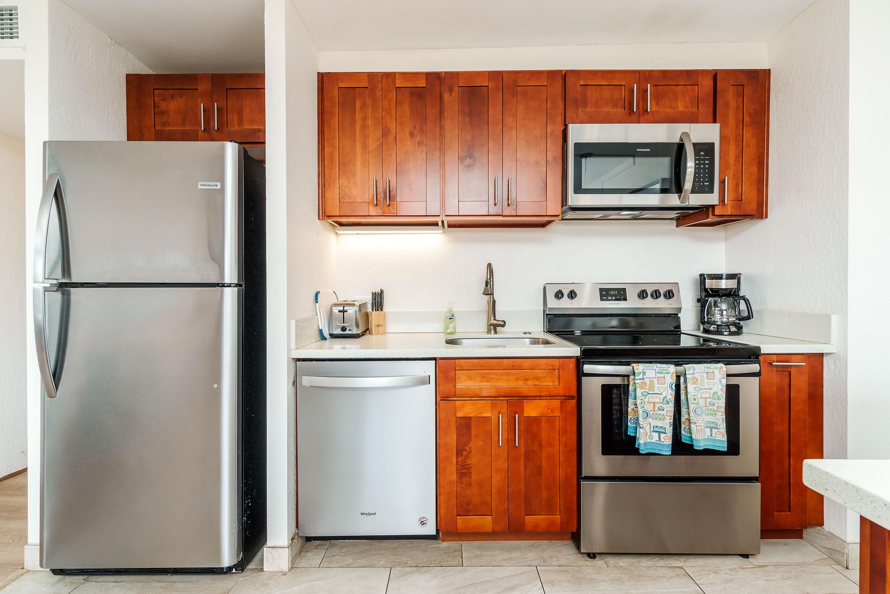 3445 Lower Honoapiilani Road, Unit 434 Lahaina, HI 96761 - Photo 15 of 46 a kitchen with stainless steel appliances granite countertop a refrigerator stove and microwave