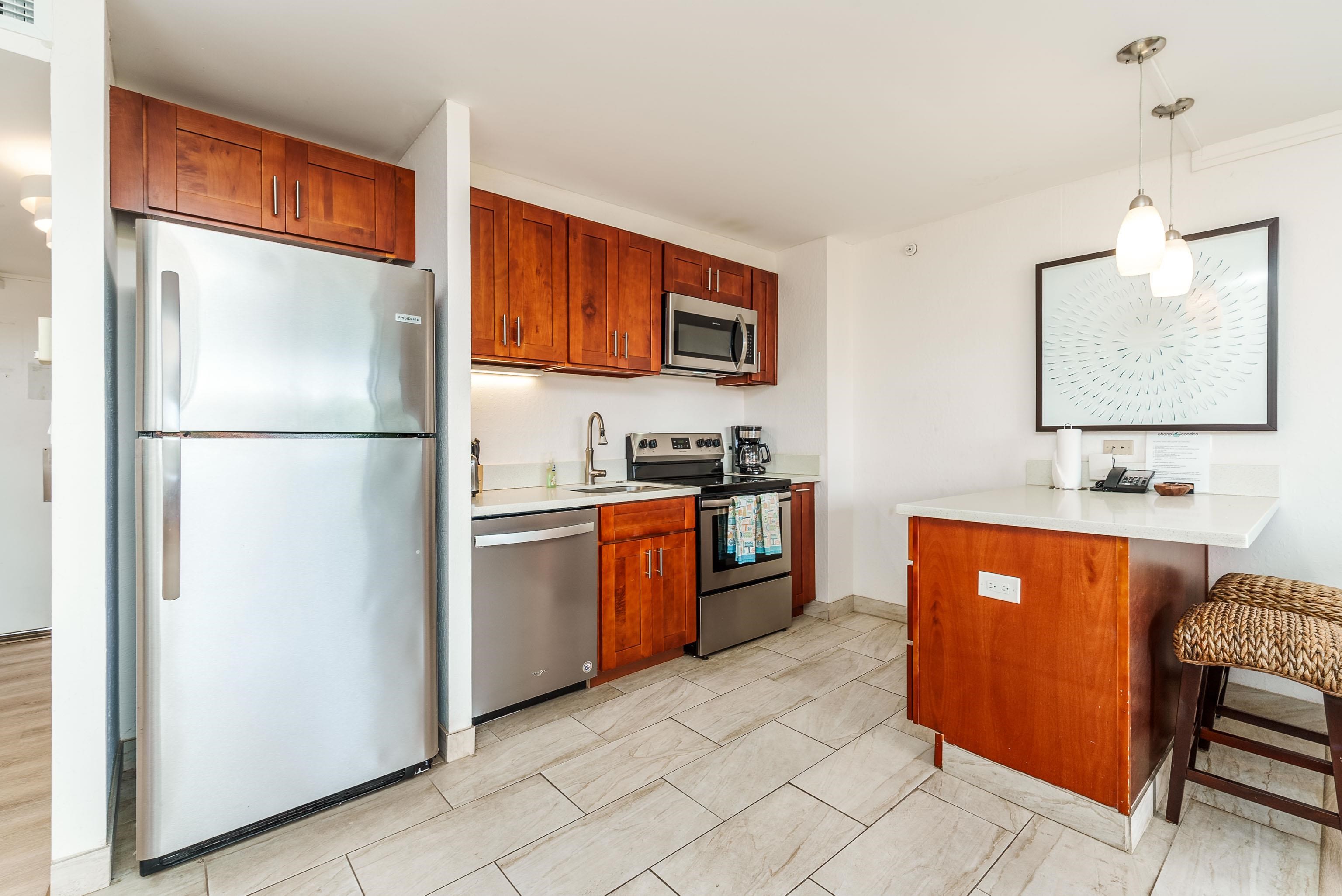 3445 Lower Honoapiilani Road, Unit 434 Lahaina, HI 96761 - Photo 16 of 46 a kitchen with stainless steel appliances granite countertop a refrigerator and a sink
