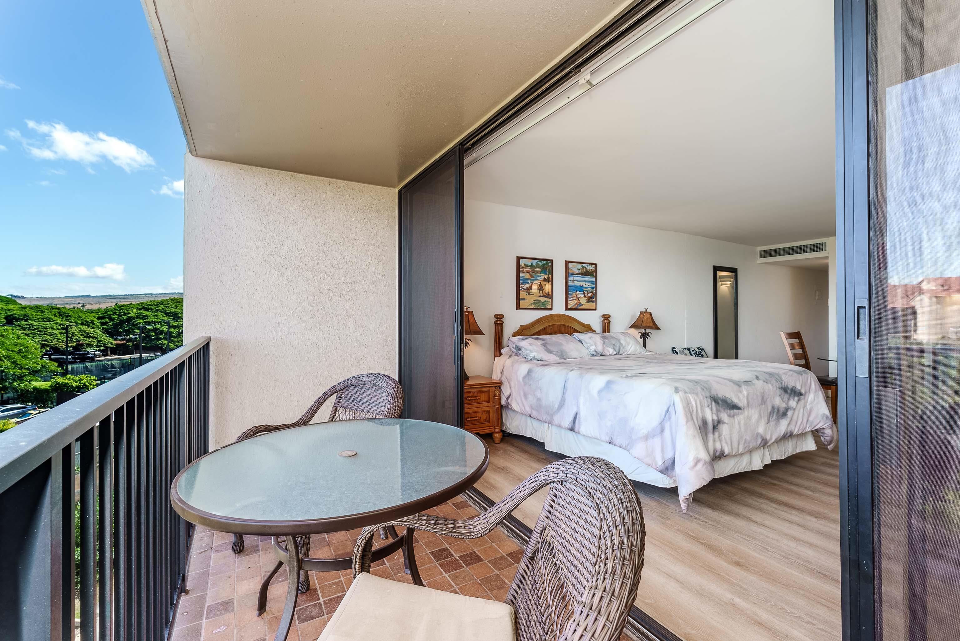 3445 Lower Honoapiilani Road, Unit 434 Lahaina, HI 96761 - Photo 4 of 46 a bedroom with bed and wooden floor