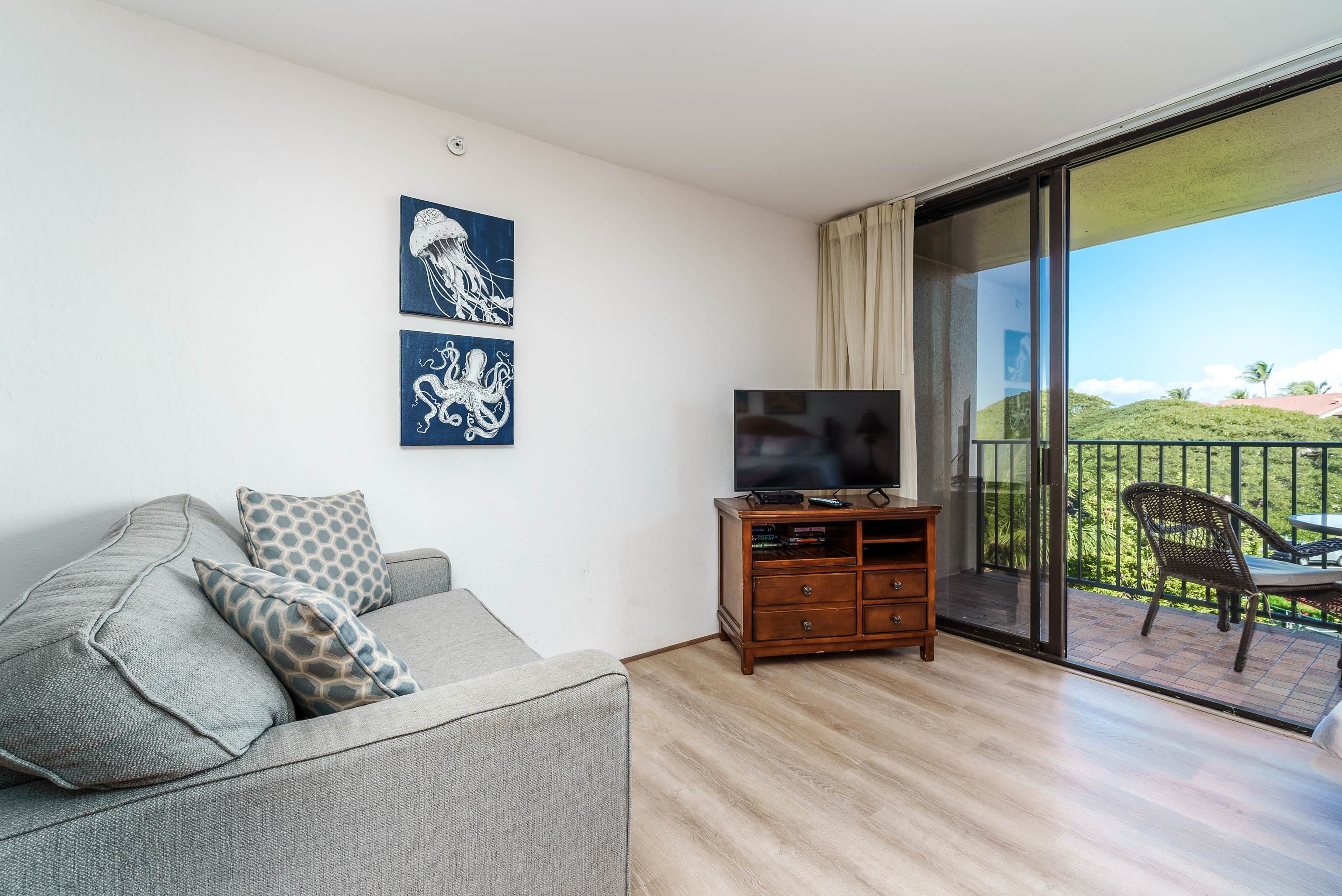 3445 Lower Honoapiilani Road, Unit 434 Lahaina, HI 96761 - Photo 8 of 46 a living room with furniture and a flat screen tv