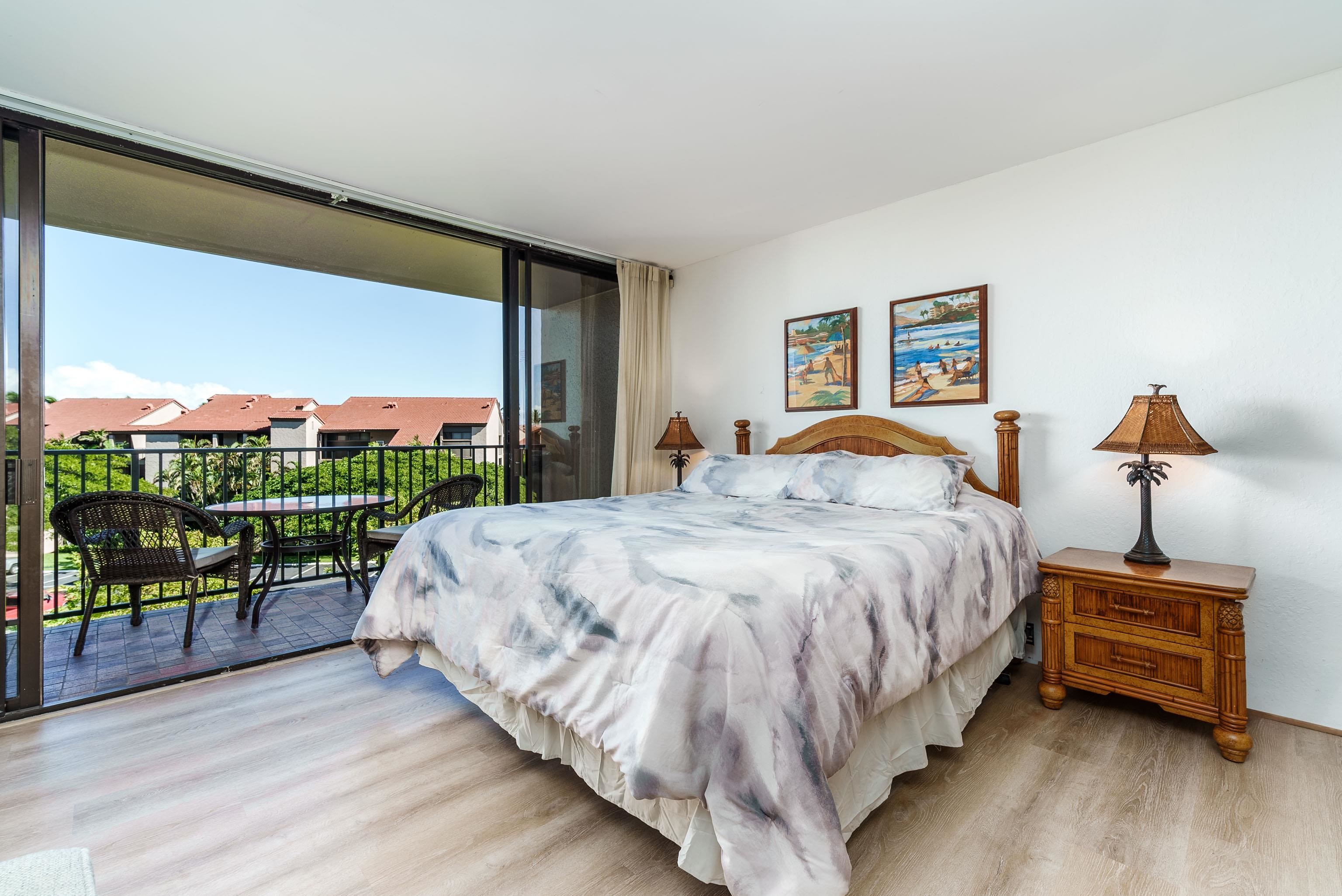 3445 Lower Honoapiilani Road, Unit 434 Lahaina, HI 96761 - Photo 9 of 46 a bedroom with a bed and wooden floor