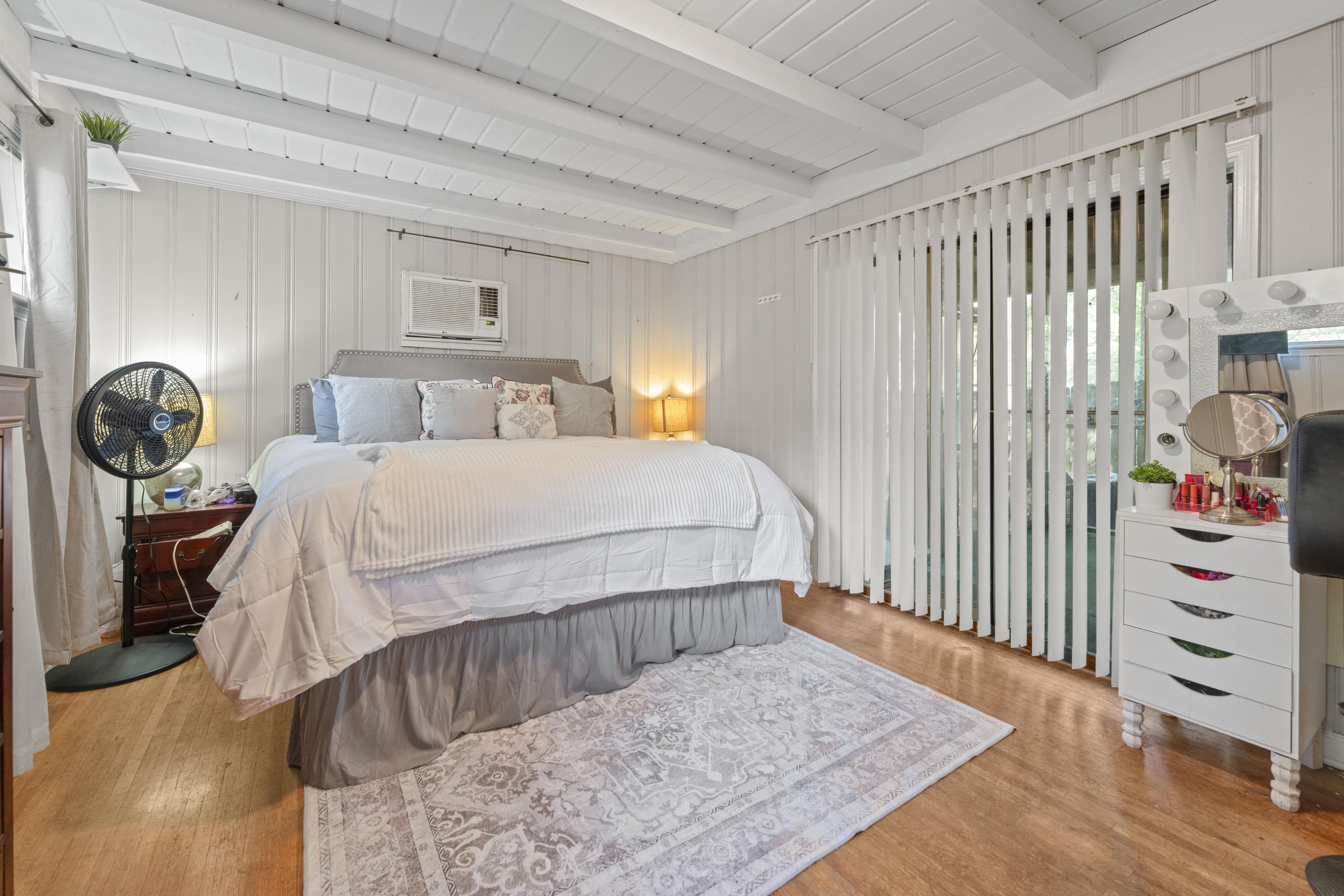 1597 Marcia Road Memphis, TN 38117 - Photo 13 of 19 a bedroom with a bed a chandelier and dresser