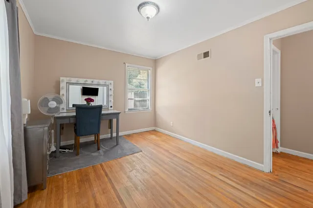 a view of a workspace with furniture and a window