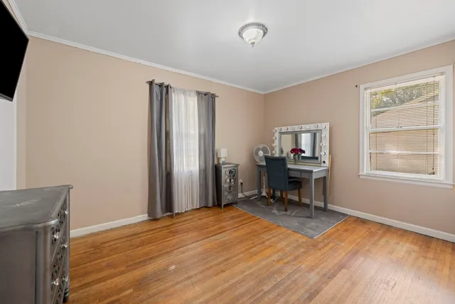 a view of a workspace with furniture and a window