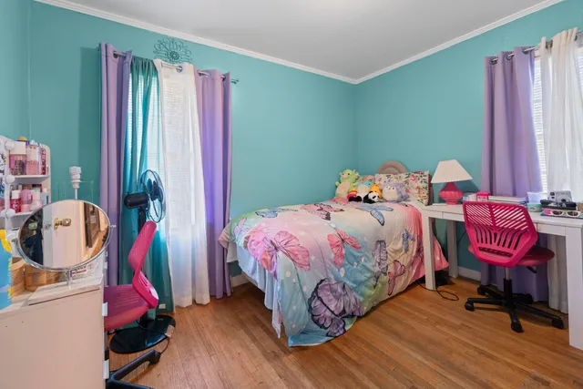 a bedroom with a bed and flat screen tv