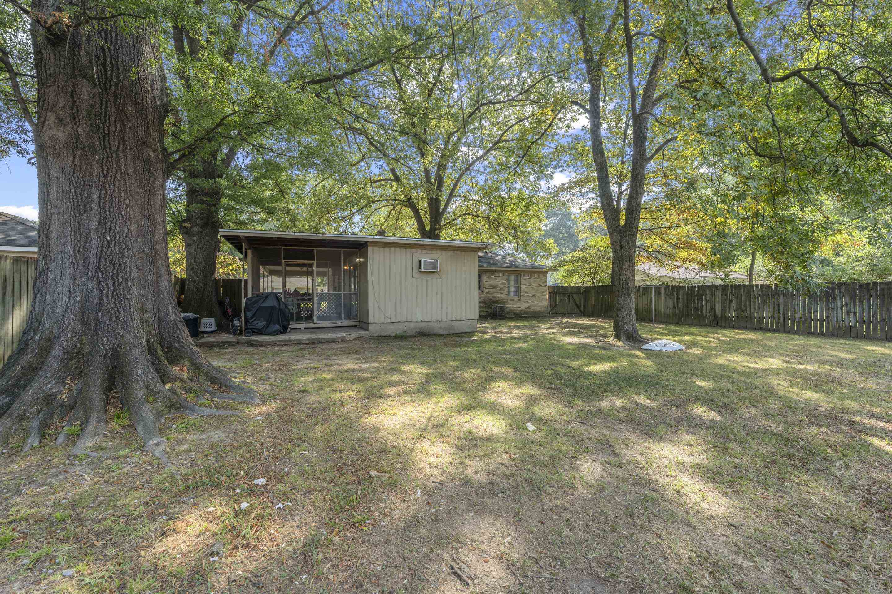 1597 Marcia Road Memphis, TN 38117 - Photo 5 of 19 a view of a house with a tree and wooden fence