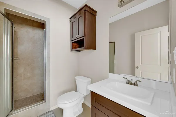a bathroom with a sink toilet and shower