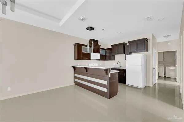 a kitchen with stainless steel appliances a refrigerator and cabinets