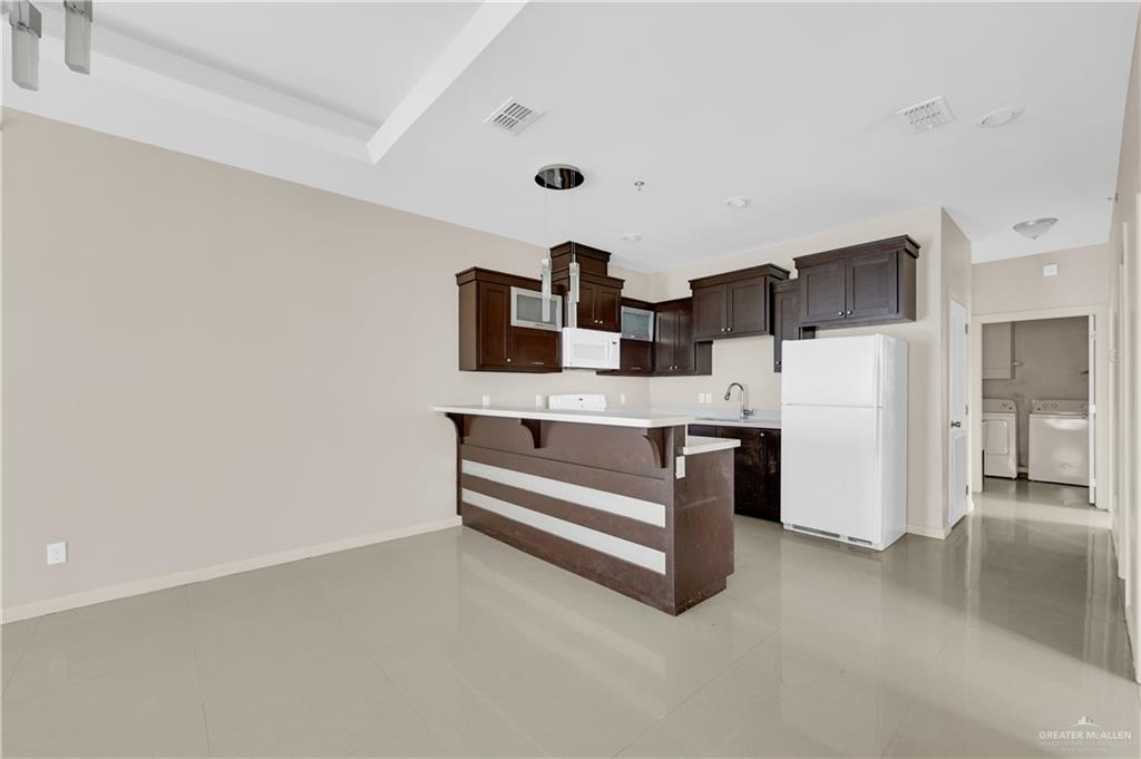 3005 South K Center Street, Unit 4 McAllen, TX 78503 - Photo 5 of 15 a kitchen with stainless steel appliances a refrigerator and cabinets