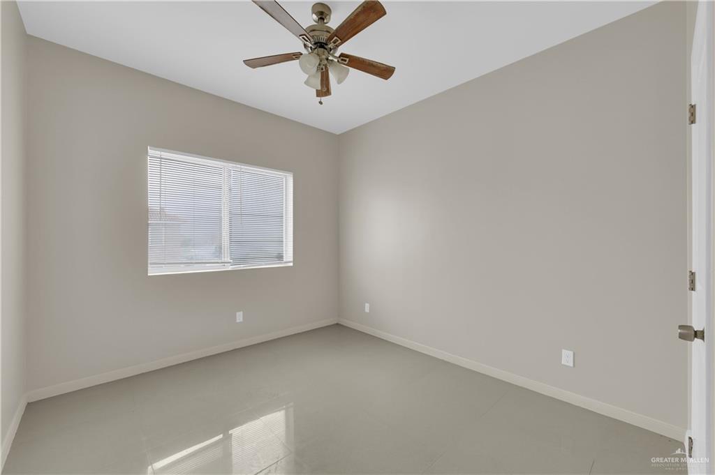 3005 South K Center Street, Unit 4 McAllen, TX 78503 - Photo 9 of 15 an empty room with a window and a fan