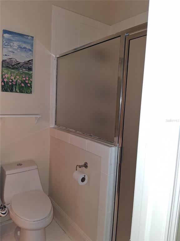 915 Old Welcome Road Lithia, FL 33547 - Photo 16 of 23 a white toilet sitting next to a shower