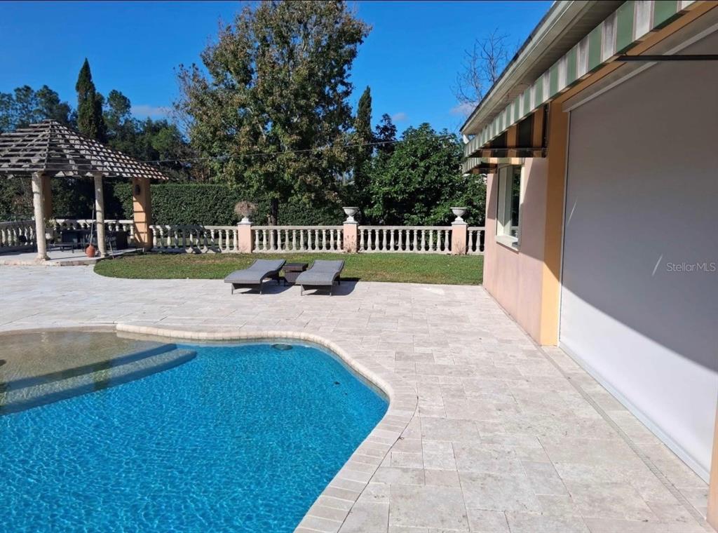 915 Old Welcome Road Lithia, FL 33547 - Photo 17 of 23 a view of a swimming pool with deck and a garden