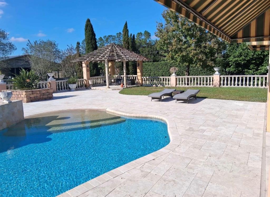 915 Old Welcome Road Lithia, FL 33547 - Photo 18 of 23 a view of a house with backyard and sitting area