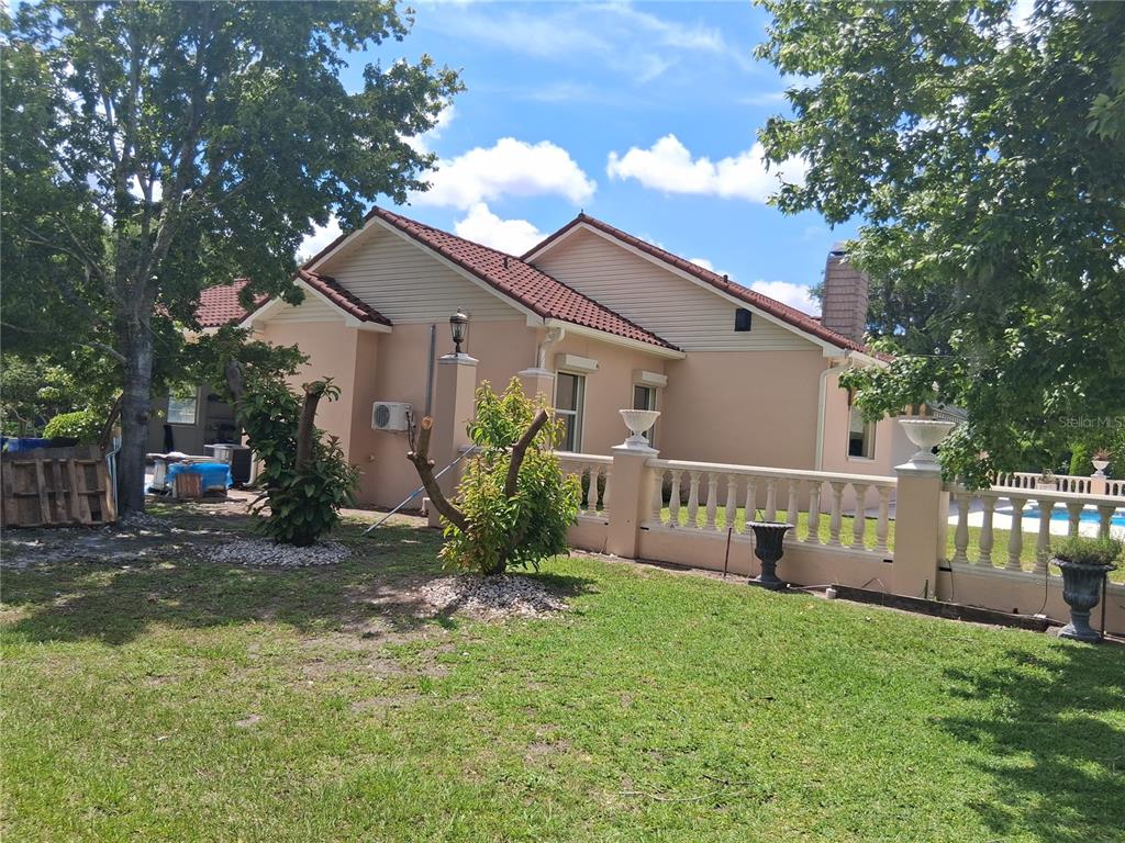 915 Old Welcome Road Lithia, FL 33547 - Photo 20 of 23 a view of a house with backyard and sitting area