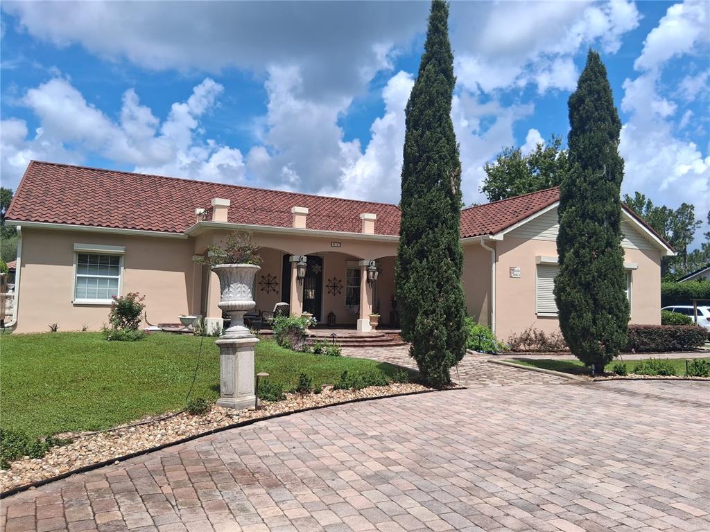 915 Old Welcome Road Lithia, FL 33547 - Photo 2 of 23 a front view of a house with garden