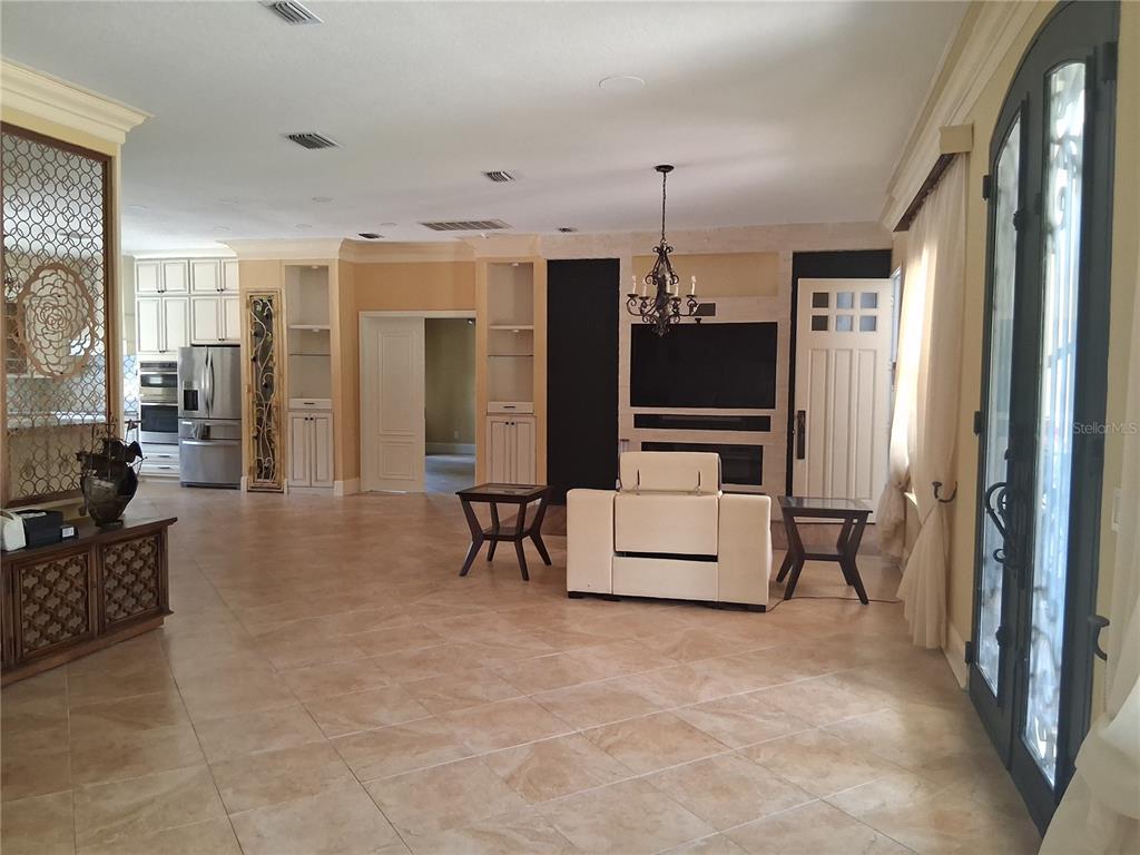 915 Old Welcome Road Lithia, FL 33547 - Photo 6 of 23 a living room with furniture and a flat screen tv