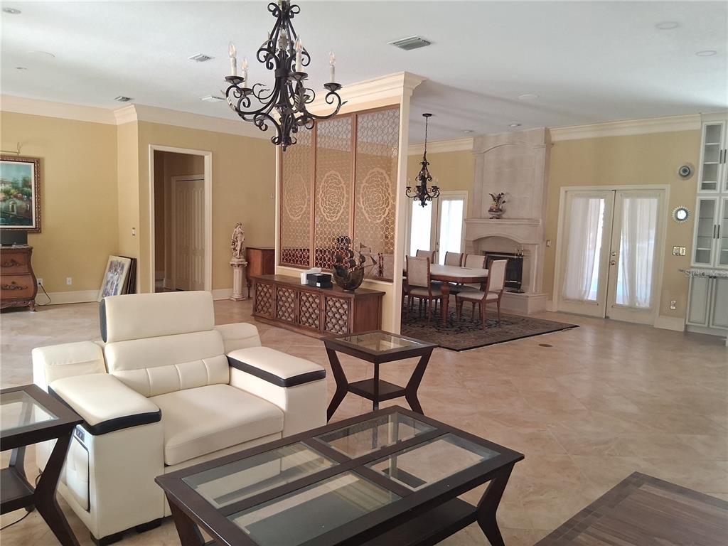 915 Old Welcome Road Lithia, FL 33547 - Photo 7 of 23 a living room with furniture a dining table and a chandelier