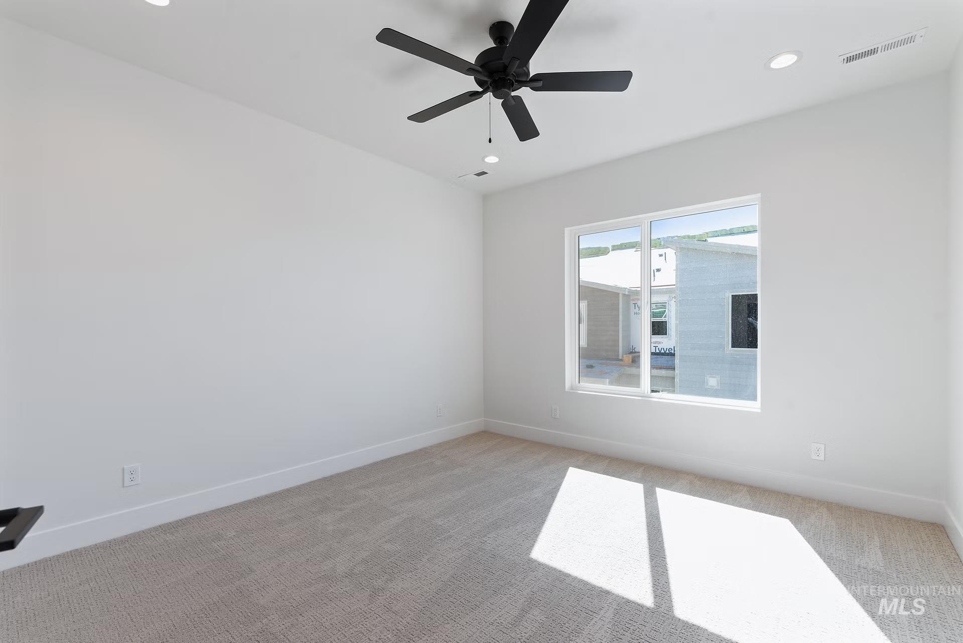 716 South Calhoun Lane Star, ID 83669 - Photo 19 of 23 Empty room with light colored carpet, recessed lighting, and ceiling fan