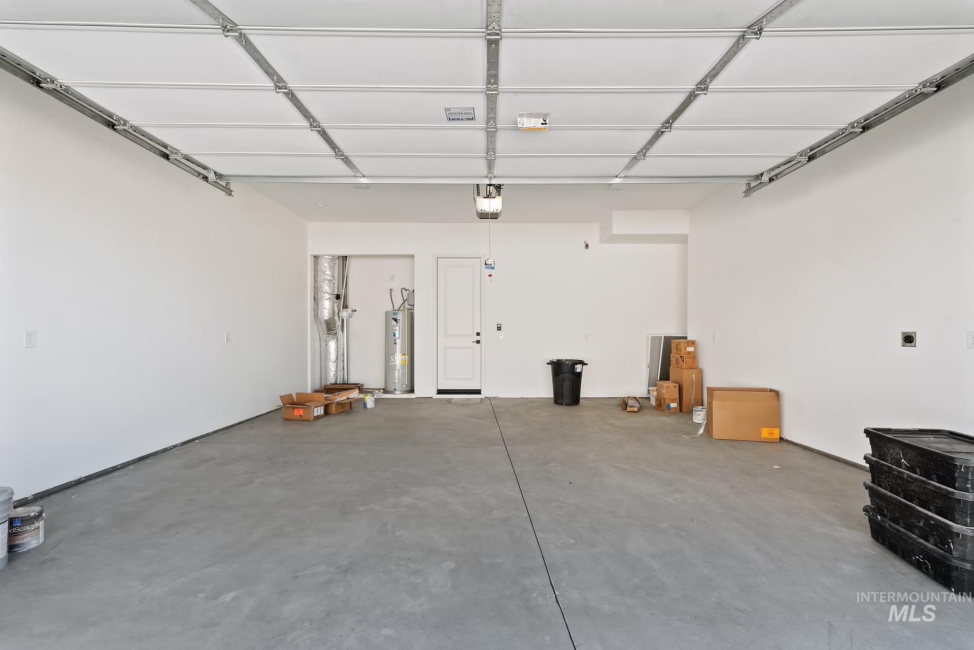 716 South Calhoun Lane Star, ID 83669 - Photo 21 of 23 Garage with electric water heater and a garage door opener
