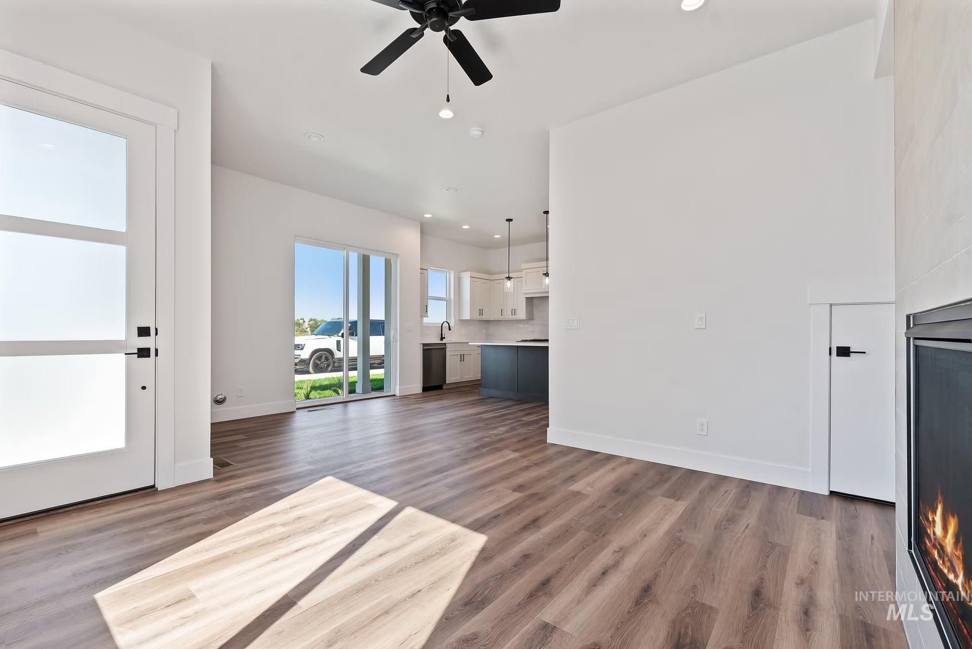 716 South Calhoun Lane Star, ID 83669 - Photo 8 of 23 Unfurnished living room with recessed lighting, ceiling fan, and dark wood-style floors