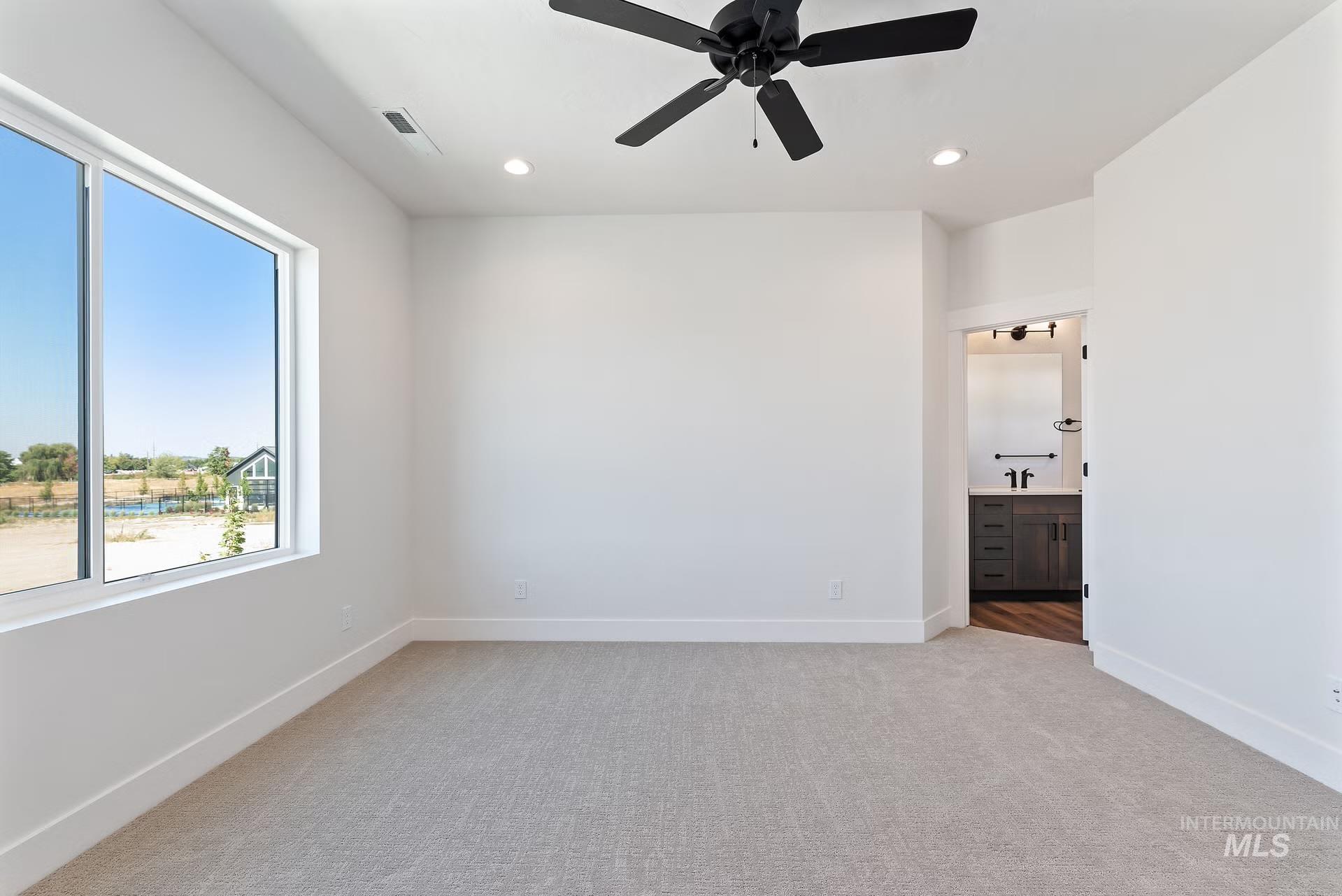 716 South Calhoun Lane Star, ID 83669 - Photo 10 of 23 Unfurnished bedroom featuring light carpet, recessed lighting, ensuite bathroom, and a ceiling fan