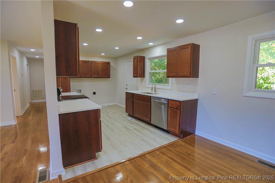 222 Odell Road Spring Lake, NC 28390 - Photo 3 of 17 a large kitchen with stainless steel appliances a large counter top a stove a sink and a refrigerator