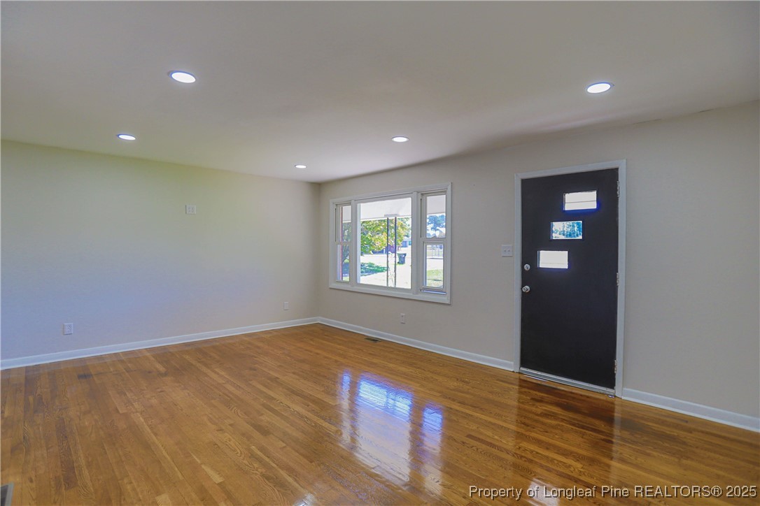 222 Odell Road Spring Lake, NC 28390 - Photo 7 of 17 a view of an empty room with wooden floor and a window