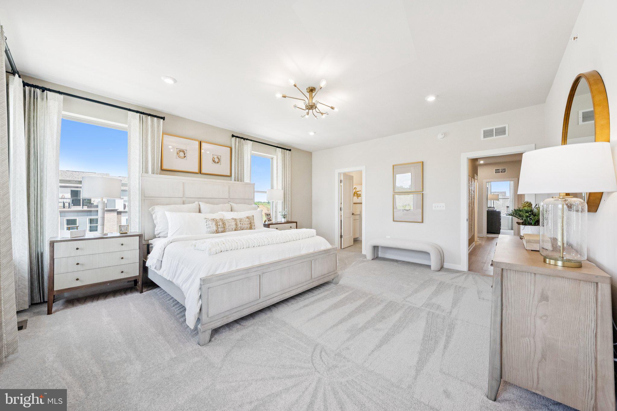 13733 Cobble Loop Woodbridge, VA 22193 - Photo 18 of 34 a spacious bedroom with a large bed and a chandelier