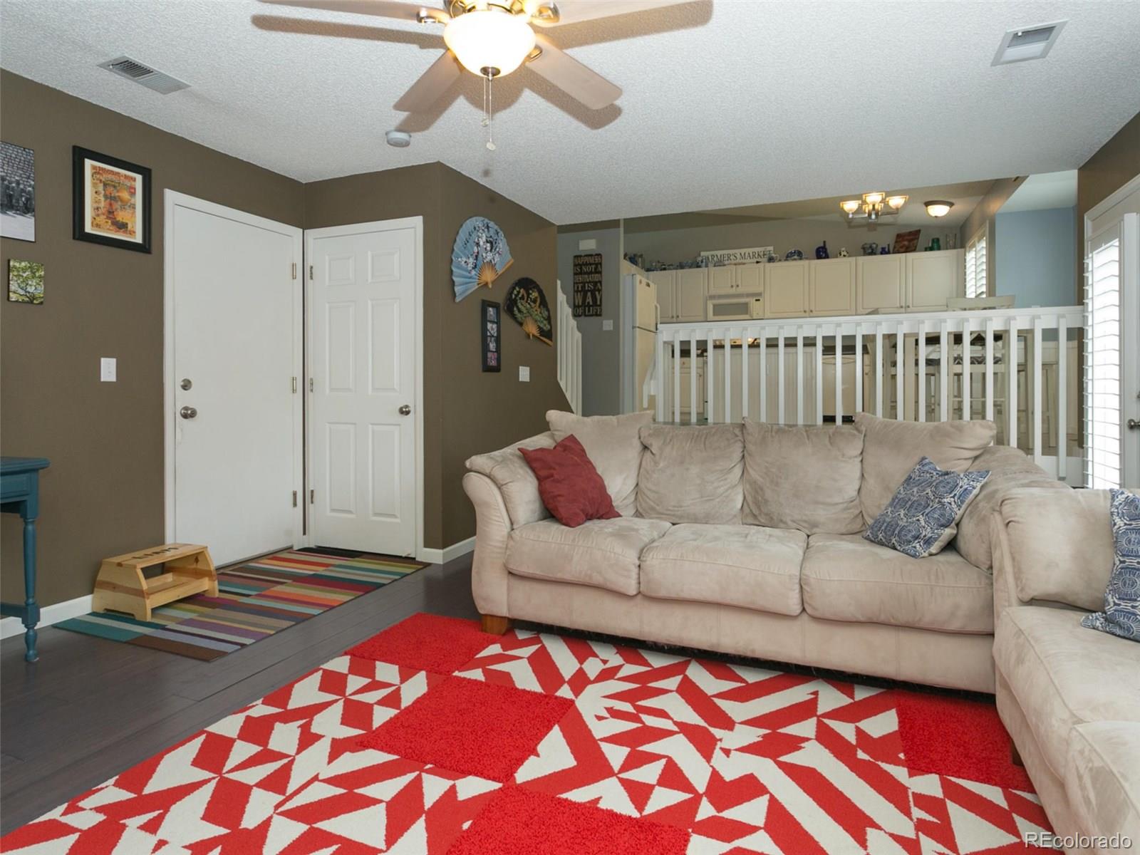 9565 South Castle Ridge Circle Highlands Ranch, CO 80129 - Photo 11 of 25 a living room with a couch and a chandelier