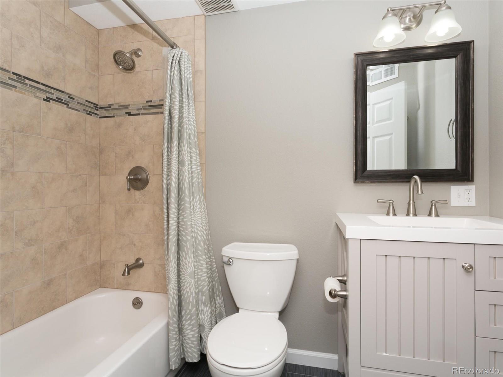 9565 South Castle Ridge Circle Highlands Ranch, CO 80129 - Photo 20 of 25 a bathroom with a toilet sink vanity tub and shower