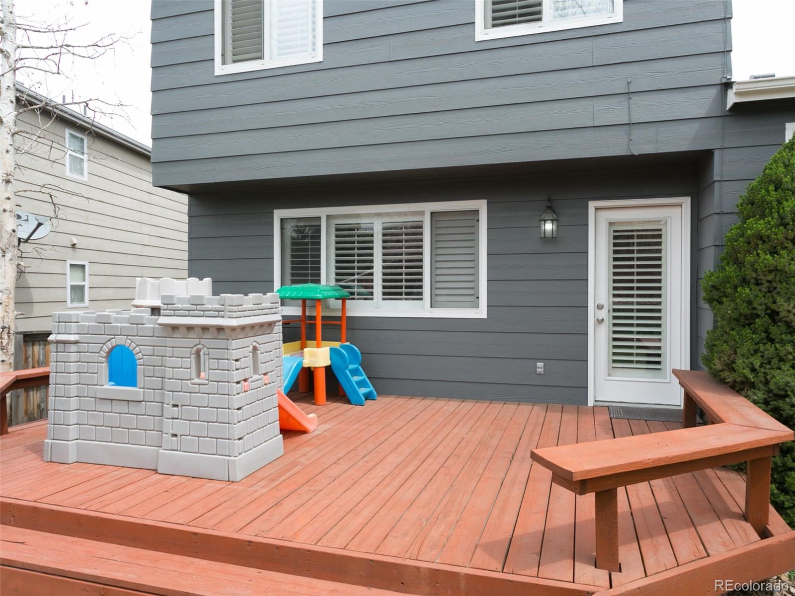 9565 South Castle Ridge Circle Highlands Ranch, CO 80129 - Photo 24 of 25 a view of a deck with a table and chairs