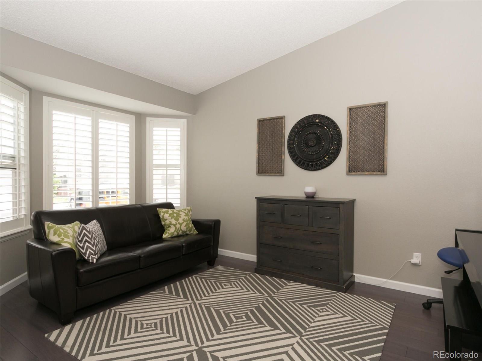 9565 South Castle Ridge Circle Highlands Ranch, CO 80129 - Photo 3 of 25 a living room with furniture and a window