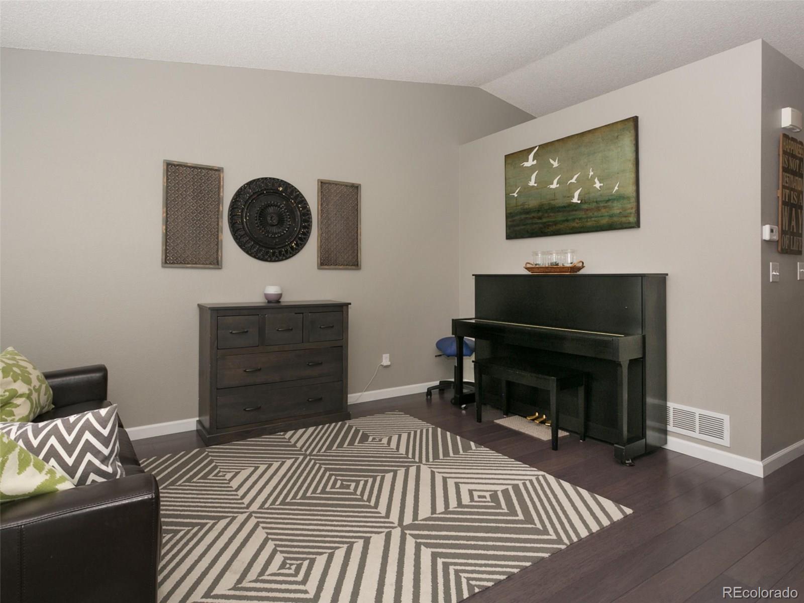 9565 South Castle Ridge Circle Highlands Ranch, CO 80129 - Photo 4 of 25 a living room with furniture and a fireplace