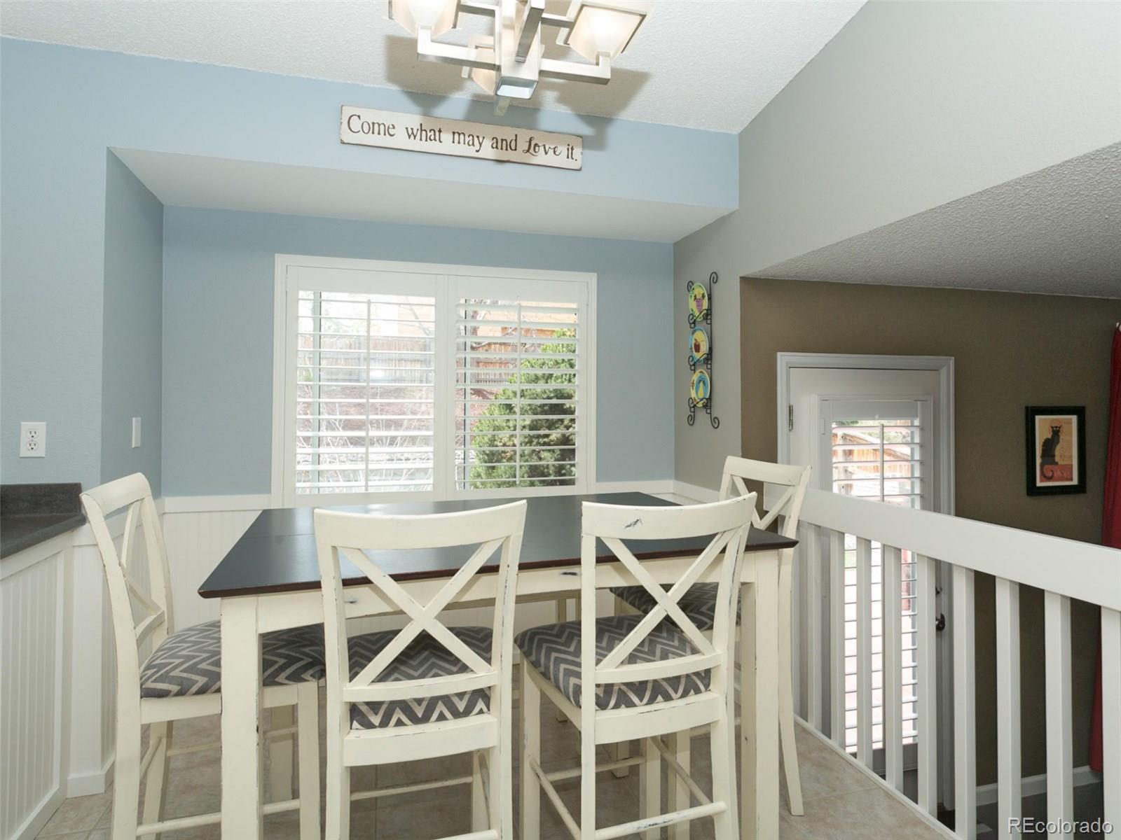 9565 South Castle Ridge Circle Highlands Ranch, CO 80129 - Photo 8 of 25 a view of a dining room with furniture wooden floor and chandelier