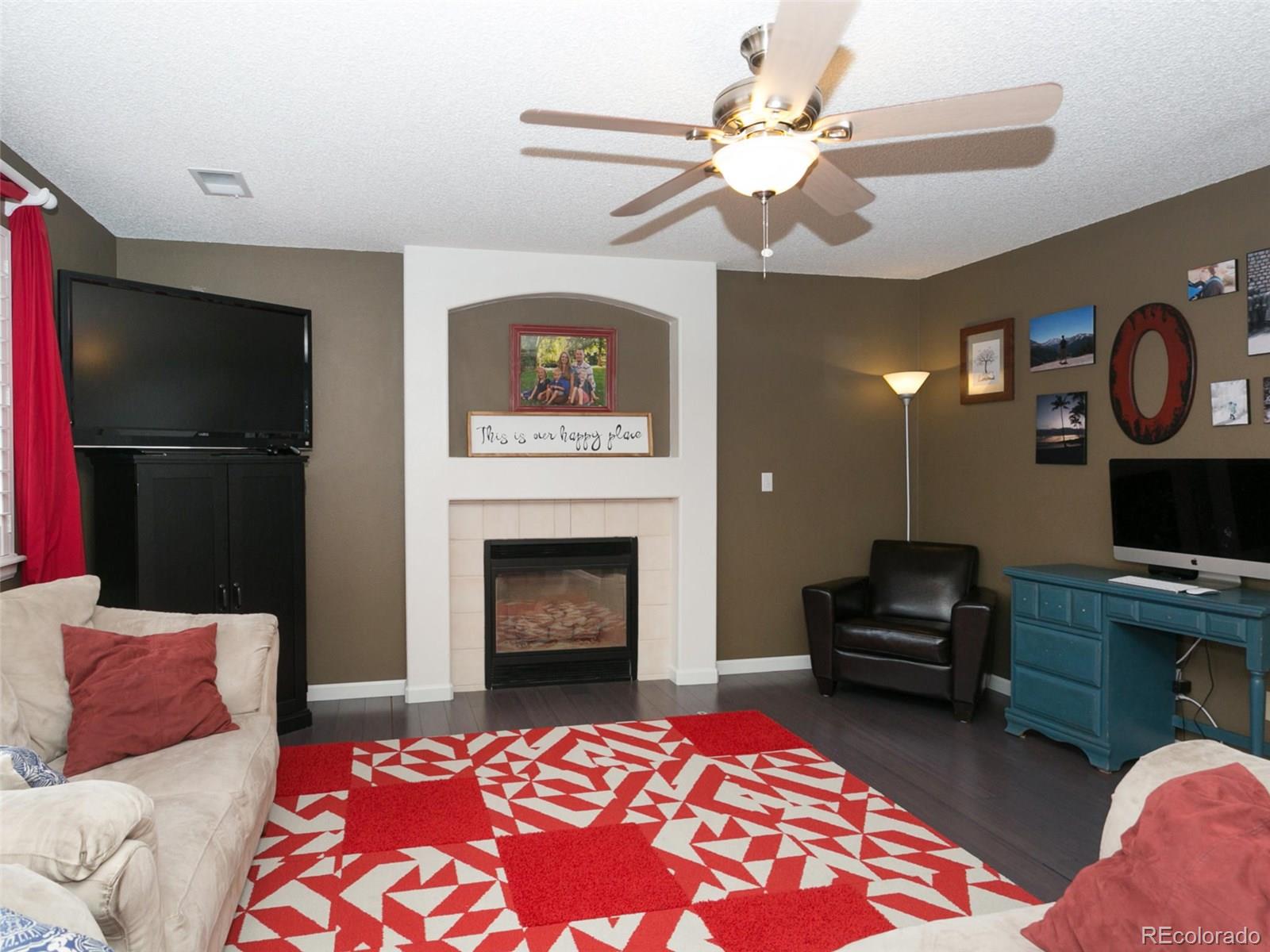 9565 South Castle Ridge Circle Highlands Ranch, CO 80129 - Photo 10 of 25 a living room with furniture and a fireplace