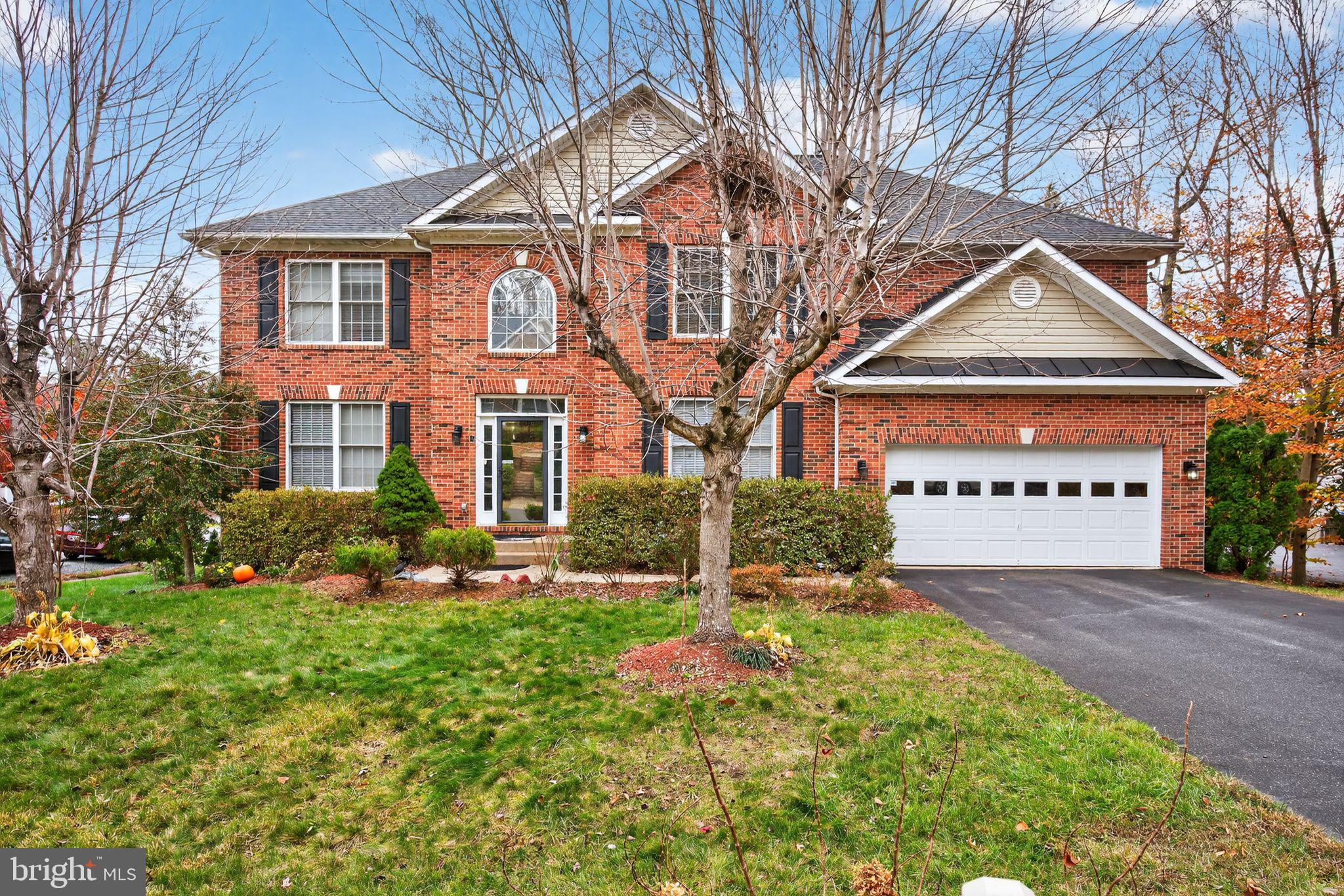 1 Pondsedge Court Stafford, VA 22554 - Photo 1 of 18 a front view of a house with a yard and garage