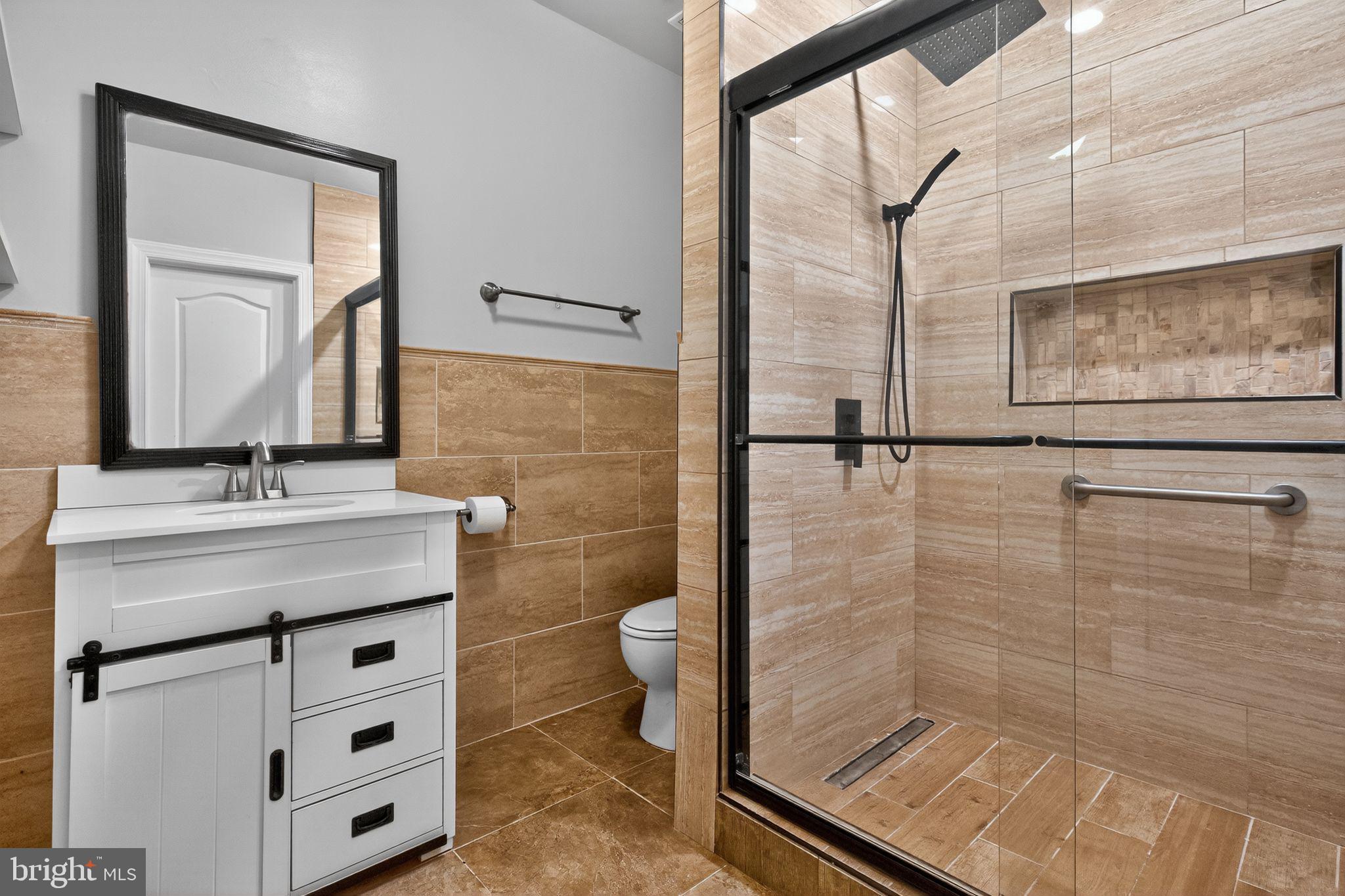 1 Pondsedge Court Stafford, VA 22554 - Photo 15 of 18 a bathroom with a sink a toilet a mirror and shower