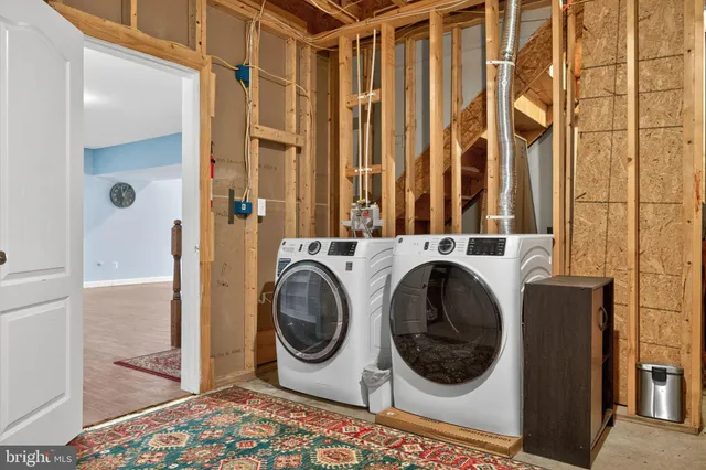 a bathroom with a sink a toilet a mirror and shower