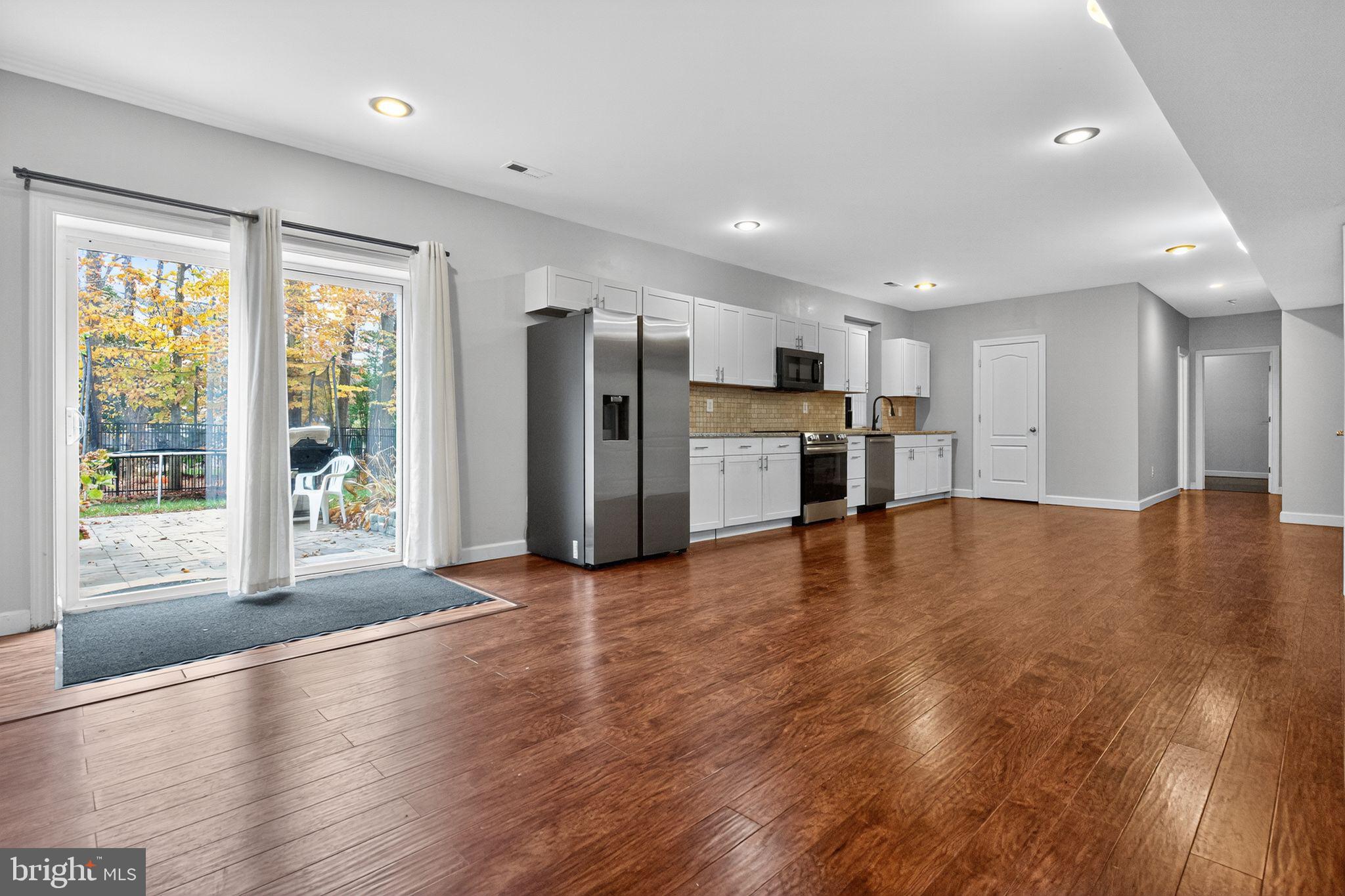 1 Pondsedge Court Stafford, VA 22554 - Photo 6 of 18 a view of a big room with wooden floor and a kitchen