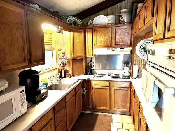 a kitchen with a sink stove and cabinets